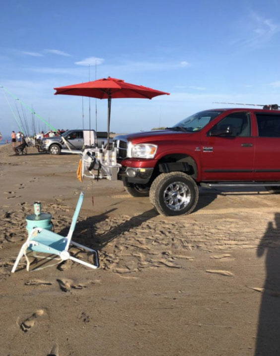 Truck parked on beach with chair