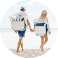 Couple walking with beach chairs